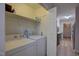 Laundry room with washer, dryer, shelves, and doorway to kitchen at 1536 Dirkson Ct, Cary, NC 27511