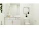 Bright bathroom featuring a white vanity with a framed mirror, modern fixtures, and toilet at 1541 Crescent Townes Way, Raleigh, NC 27604