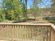 A backyard view from the deck, with lush green trees, vegetation, and a nice lawn at 164 Sue Dr, Angier, NC 27501