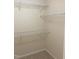 A standard closet with multiple white shelves on the beige colored walls for storage at 164 Sue Dr, Angier, NC 27501