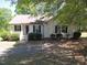 Charming one-story home featuring a cozy front porch and mature trees at 164 Sue Dr, Angier, NC 27501