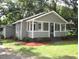 Charming one-story home featuring a covered front porch and mature landscaping at 176 Fletcher Ave, Fuquay Varina, NC 27526