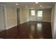 Bright living room boasts gleaming hardwood floors, neutral paint, and natural light at 176 Fletcher Ave, Fuquay Varina, NC 27526