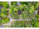 Residential property surrounded by lush trees and landscaping from an aerial perspective at 2001 Virginia Dare Pl, Raleigh, NC 27610