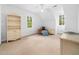 Bright bedroom with plush carpet, decorated with white walls, ceiling fan, and built-in shelving at 2001 Virginia Dare Pl, Raleigh, NC 27610