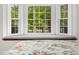 Close up of bay window in bedroom with window seat and floral bedding at 2001 Virginia Dare Pl, Raleigh, NC 27610