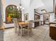Bright dining room with a large window, chandelier, and tiled flooring, and open access to kitchen at 2001 Virginia Dare Pl, Raleigh, NC 27610