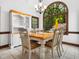 Dining room featuring a large arched window with wooded views, a chandelier, and a corner hutch at 2001 Virginia Dare Pl, Raleigh, NC 27610