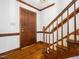 Inviting foyer with wood floors, stairs, and door with rich wooden trim throughout the entryway at 2001 Virginia Dare Pl, Raleigh, NC 27610