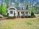 Charming two-story home with a brick walkway, front porch, and landscaped yard at 2001 Virginia Dare Pl, Raleigh, NC 27610