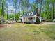Charming two-story home with a brick chimney, front porch, and mature landscaping at 2001 Virginia Dare Pl, Raleigh, NC 27610
