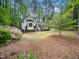 Charming two-story home with a brick walkway, front porch, and blooming flower beds at 2001 Virginia Dare Pl, Raleigh, NC 27610