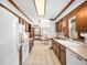 Spacious kitchen with white appliances, wooden cabinets, tile floors, and an adjacent breakfast nook at 2001 Virginia Dare Pl, Raleigh, NC 27610