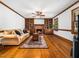Spacious living room featuring hardwood floors, a brick fireplace with built-in bookshelves, and natural light at 2001 Virginia Dare Pl, Raleigh, NC 27610