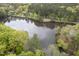 Aerial view of lake surrounded by lush green trees and residential area, creating a peaceful environment at 208 Clark Lake Rd, Durham, NC 27707