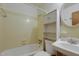 Bathroom with tub/shower, cabinet, and sink with bright lighting at 208 Clark Lake Rd, Durham, NC 27707
