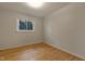 Comfortable bedroom with hardwood floors and a bright window at 208 Clark Lake Rd, Durham, NC 27707