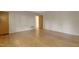 Inviting bedroom featuring hardwood floors, neutral walls, and a closet for storage solutions at 208 Clark Lake Rd, Durham, NC 27707
