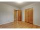 Bedroom featuring hardwood floors and a door to an adjoining room at 208 Clark Lake Rd, Durham, NC 27707