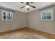 Well-lit bedroom with hardwood flooring and scenic outdoor views at 208 Clark Lake Rd, Durham, NC 27707