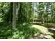 Secluded single story brick home with mature trees and landscaping on a wooded lot at 208 Clark Lake Rd, Durham, NC 27707