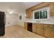 Bright kitchen with stainless steel appliances, white countertops, and eat-in dining area at 208 Clark Lake Rd, Durham, NC 27707