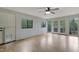 Bright living room with double doors to a deck and two windows for light and scenic views at 208 Clark Lake Rd, Durham, NC 27707