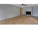 Open-concept living room featuring hardwood floors and a cozy fireplace at 208 Clark Lake Rd, Durham, NC 27707