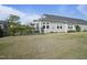 A well-manicured lawn with an attractive house featuring a covered patio and a black metal fence at 21 Davidson St, Clayton, NC 27527