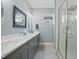 Stylish bathroom with double vanity, white countertops, and glass-enclosed shower at 21 Davidson St, Clayton, NC 27527