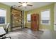 Bright bedroom with a large bookcase, ceiling fan, and wood-look flooring at 21 Davidson St, Clayton, NC 27527