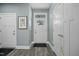 Entryway featuring a decorative front door, two closets, and hardwood style floors at 21 Davidson St, Clayton, NC 27527