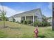 Charming home featuring a covered porch, well-maintained lawn, and beautiful landscaping at 21 Davidson St, Clayton, NC 27527