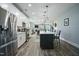 Modern kitchen featuring stainless steel appliances, white cabinets, and hardwood floors that open up to living area at 21 Davidson St, Clayton, NC 27527