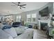 Comfortable living room featuring a fireplace, lots of windows, a ceiling fan, and luxury furnishings at 21 Davidson St, Clayton, NC 27527