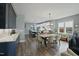 Open-concept living space with kitchen, dining area, and living room featuring hardwood floors and lots of natural light at 21 Davidson St, Clayton, NC 27527
