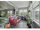 Bright sunroom filled with natural light, a comfortable sofa, and lots of plants, perfect for relaxation at 21 Davidson St, Clayton, NC 27527