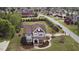 Aerial view showcases a gray two-story home with manicured landscaping and a welcoming front porch at 2113 Rockwall Farms Ln, Fuquay Varina, NC 27526