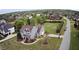 Aerial view of gray home with inviting curb appeal, surrounded by lush greenery and neighborhood views at 2113 Rockwall Farms Ln, Fuquay Varina, NC 27526