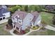 Aerial view of a gray two-story home with a well-manicured yard and a driveway leading to a garage at 2113 Rockwall Farms Ln, Fuquay Varina, NC 27526