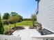 Backyard view, featuring a neatly manicured lawn and a charming stone patio at 2113 Rockwall Farms Ln, Fuquay Varina, NC 27526