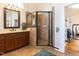 Charming bathroom with tile floors, a glass shower and wooden cabinets at 2113 Rockwall Farms Ln, Fuquay Varina, NC 27526