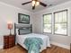 Comfortable bedroom with hardwood floors, bright windows and a cozy bed at 2113 Rockwall Farms Ln, Fuquay Varina, NC 27526