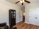 Comfortable bedroom featuring hardwood floors, and an antique armoire at 2113 Rockwall Farms Ln, Fuquay Varina, NC 27526