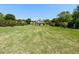 Expansive front yard featuring lush green grass and a charming two-story home in the background at 2113 Rockwall Farms Ln, Fuquay Varina, NC 27526