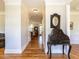 Elegant hallway with hardwood floors, white trim, and decorative table, leading into the living space at 2113 Rockwall Farms Ln, Fuquay Varina, NC 27526