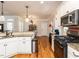 Spacious kitchen with white cabinets, granite countertops, stainless steel appliances, and hardwood floors at 2113 Rockwall Farms Ln, Fuquay Varina, NC 27526