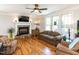 Cozy living room with stone fireplace, large windows and hardwood flooring at 2113 Rockwall Farms Ln, Fuquay Varina, NC 27526