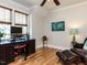 A bright home office with hardwood flooring, a ceiling fan, and plenty of natural light at 2113 Rockwall Farms Ln, Fuquay Varina, NC 27526