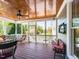 Screened-in porch with ceiling fan and charming seating, perfect for relaxing at 2113 Rockwall Farms Ln, Fuquay Varina, NC 27526